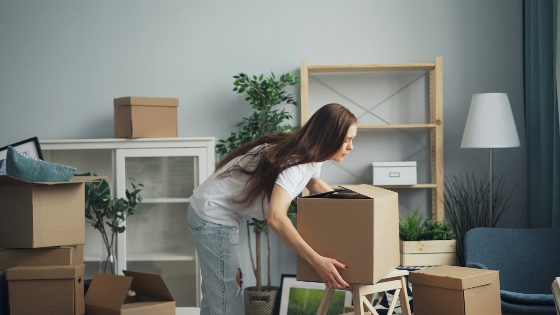 Unpacking boxes in a bright, settled Bay Area home after a Brother Movers move